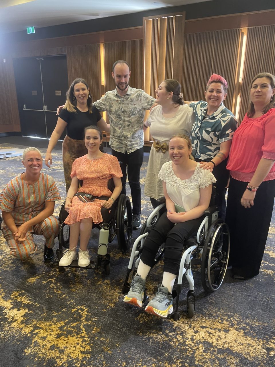 An image of CPActive Champions, Cerebral Palsy Alliance staff and Hannah Diviney all pose together for a picture in National Press Gallery room in Canberra.